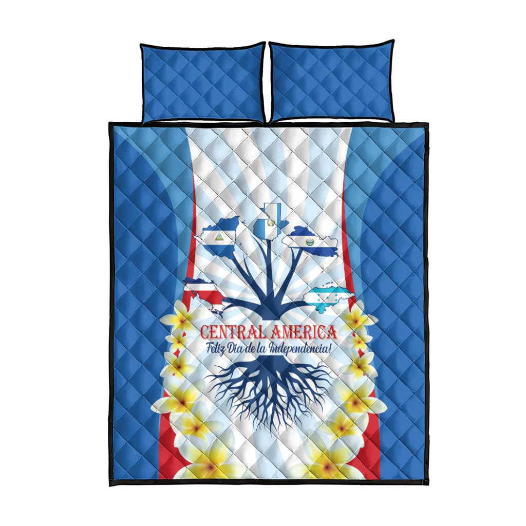 Blue quilt bed set front view with Central America emblem, flowers, and two pillow covers