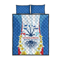Blue quilt bed set front view with Central America emblem, flowers, and two pillow covers