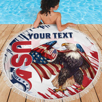 Round white beach blanket with fringe, eagle and patriotic rugby graphics, on wooden deck