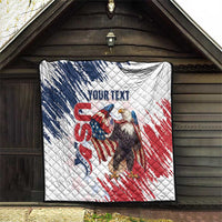 White quilt hanging on porch with American flag eagle graphic and quilted diamond pattern.