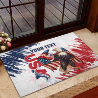 Rectangular doormat with US eagle artwork, red and blue paint-stroke background, custom text