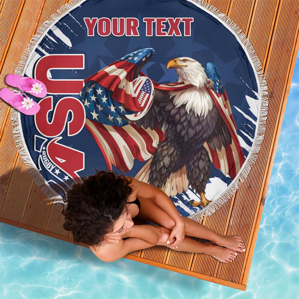 Round blue beach blanket with eagle and American rugby graphic, white fringe edge.