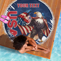 Round blue beach blanket with eagle and American rugby graphic, white fringe edge.