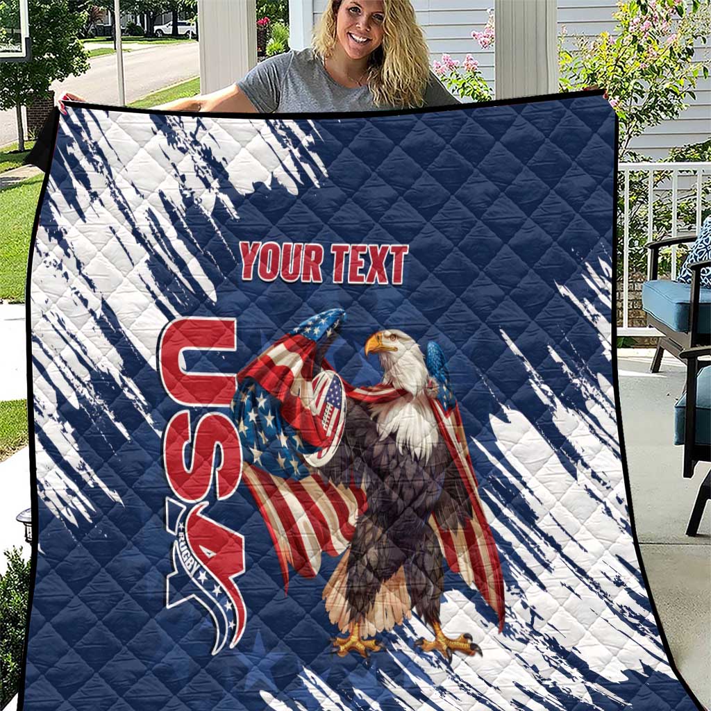 Blue and white quilt with quilted pattern and American eagle graphic with red text