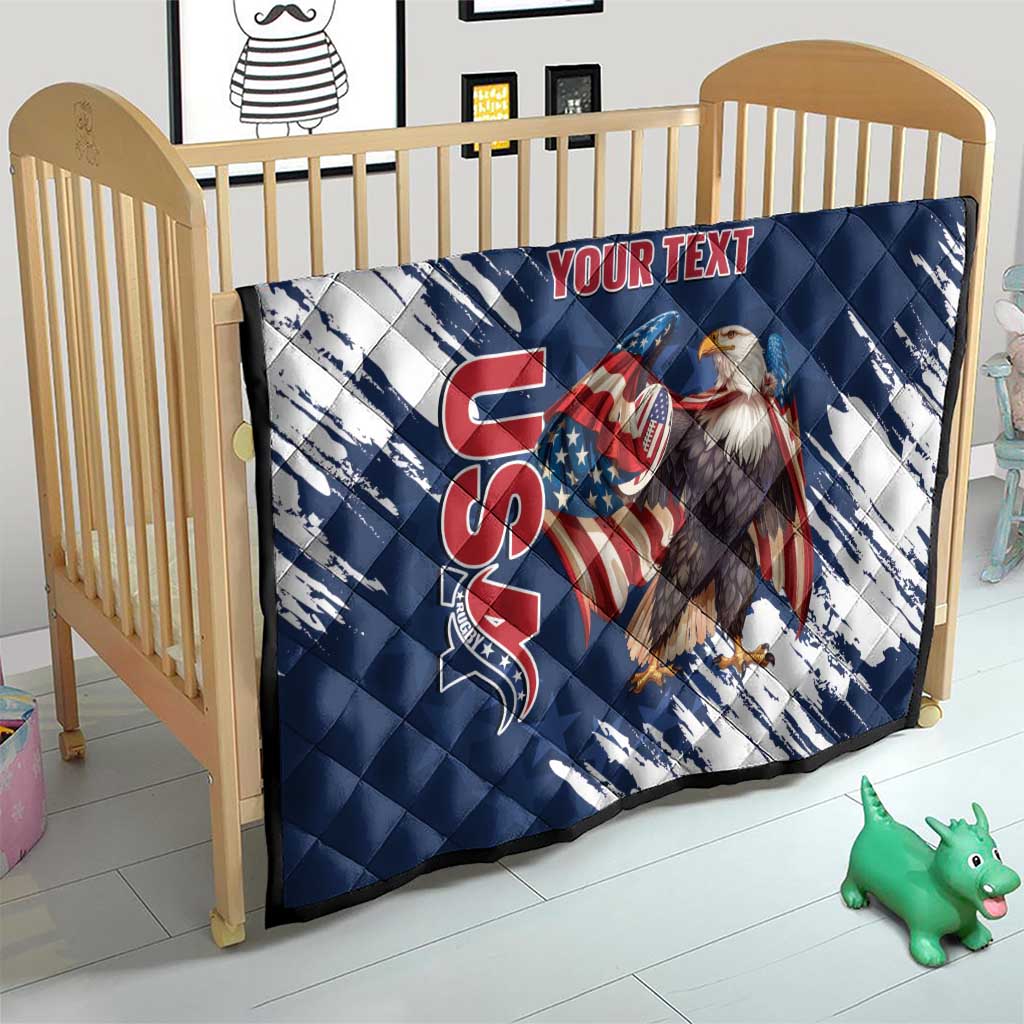 Blue and white quilt on a wooden crib, quilted design with eagle graphic and red “YOUR TEXT”