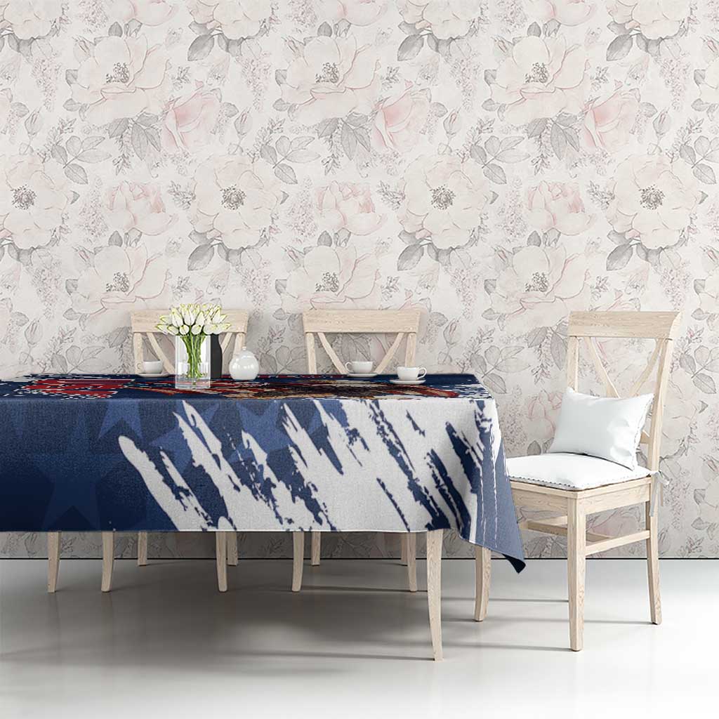 Blue tablecloth with eagle graphic and white brush streaks on dining setup