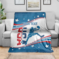 Basketball blanket draped over sofa, white and blue with red stripes, stars, and custom text