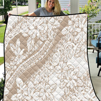 Beige quilt with white floral leaf pattern and diamond quilting, black-trim edges.