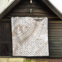 Beige quilt with white flower and swirl pattern, diamond quilting, black-trim perimeter.