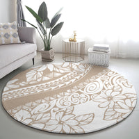 Round area rug with beige base and white floral scroll design