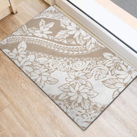 Beige indoor doormat with white tropical leaves, flowers, and swirling motifs