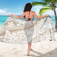 Beige sarong with white floral and geometric swirl print, worn as a wrap skirt