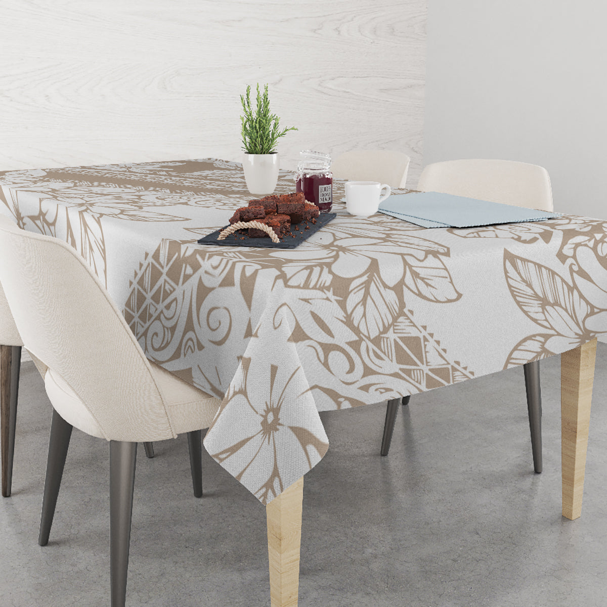 Beige and white floral leaf tablecloth with ornate linework, spread across table