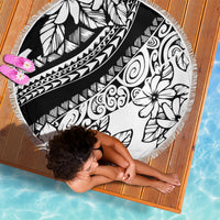 Round beach blanket featuring black and white tropical leaf and flower print with fringe