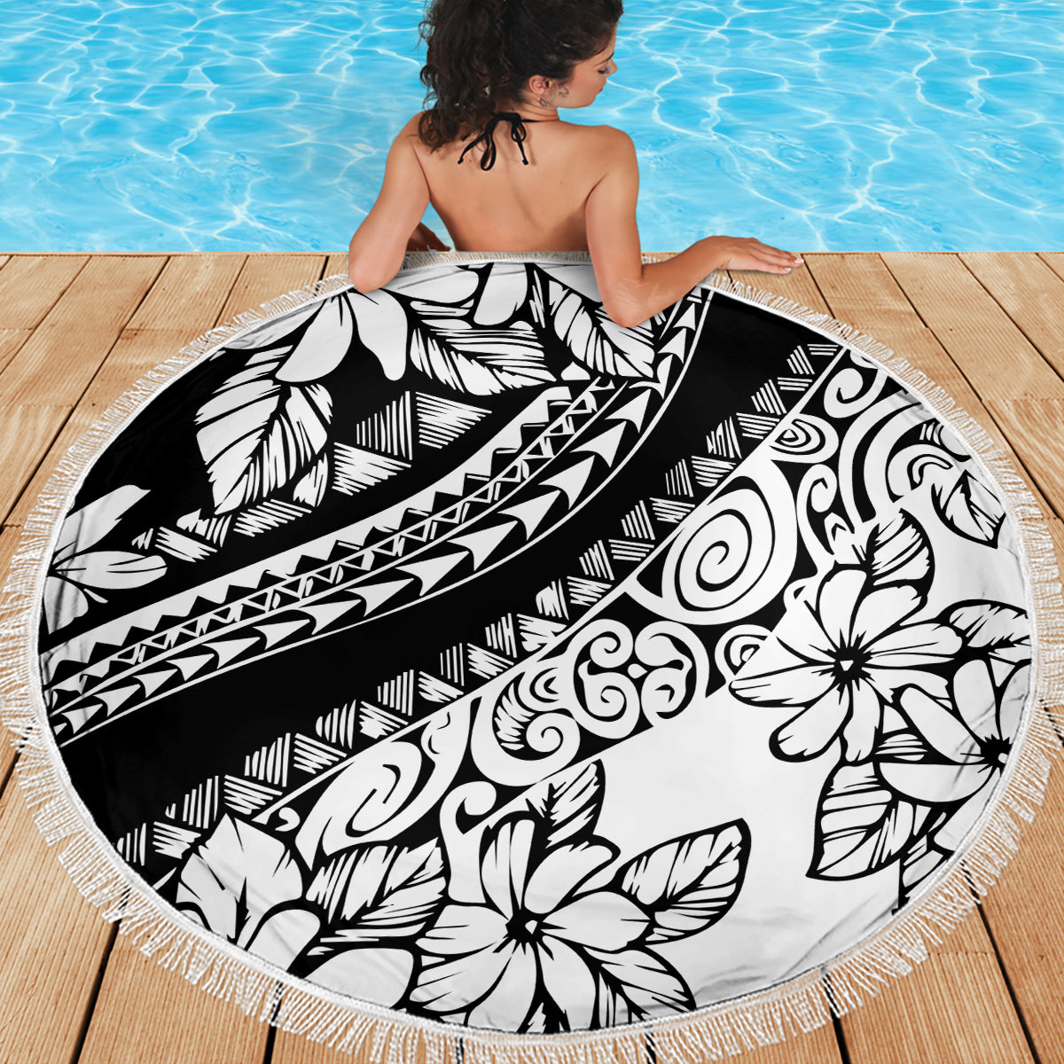 Round black and white floral beach blanket with patterned center and fringed border