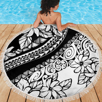 Round black and white floral beach blanket with patterned center and fringed border