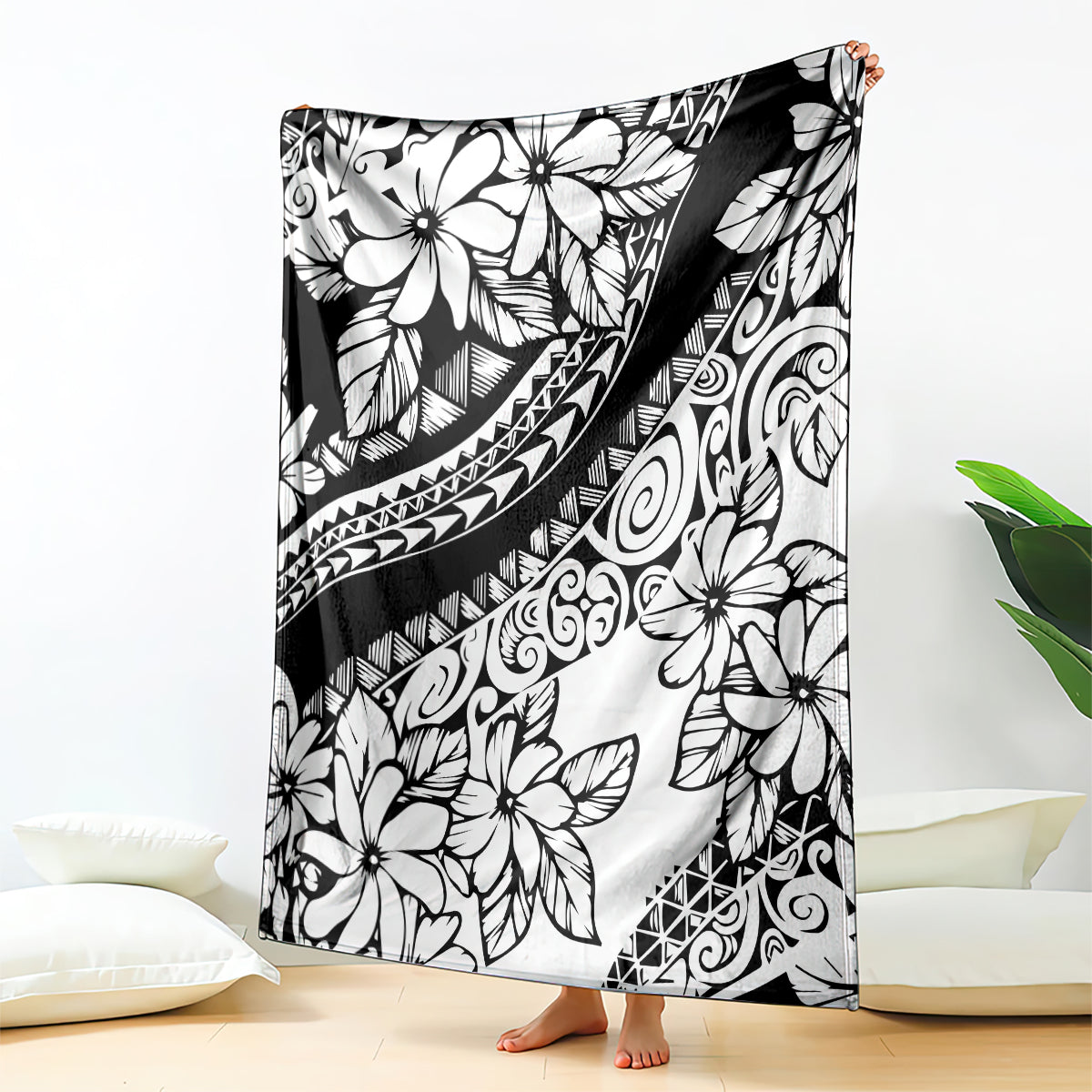 Black tropical flower blanket with tribal swirl patterns, draped over furniture
