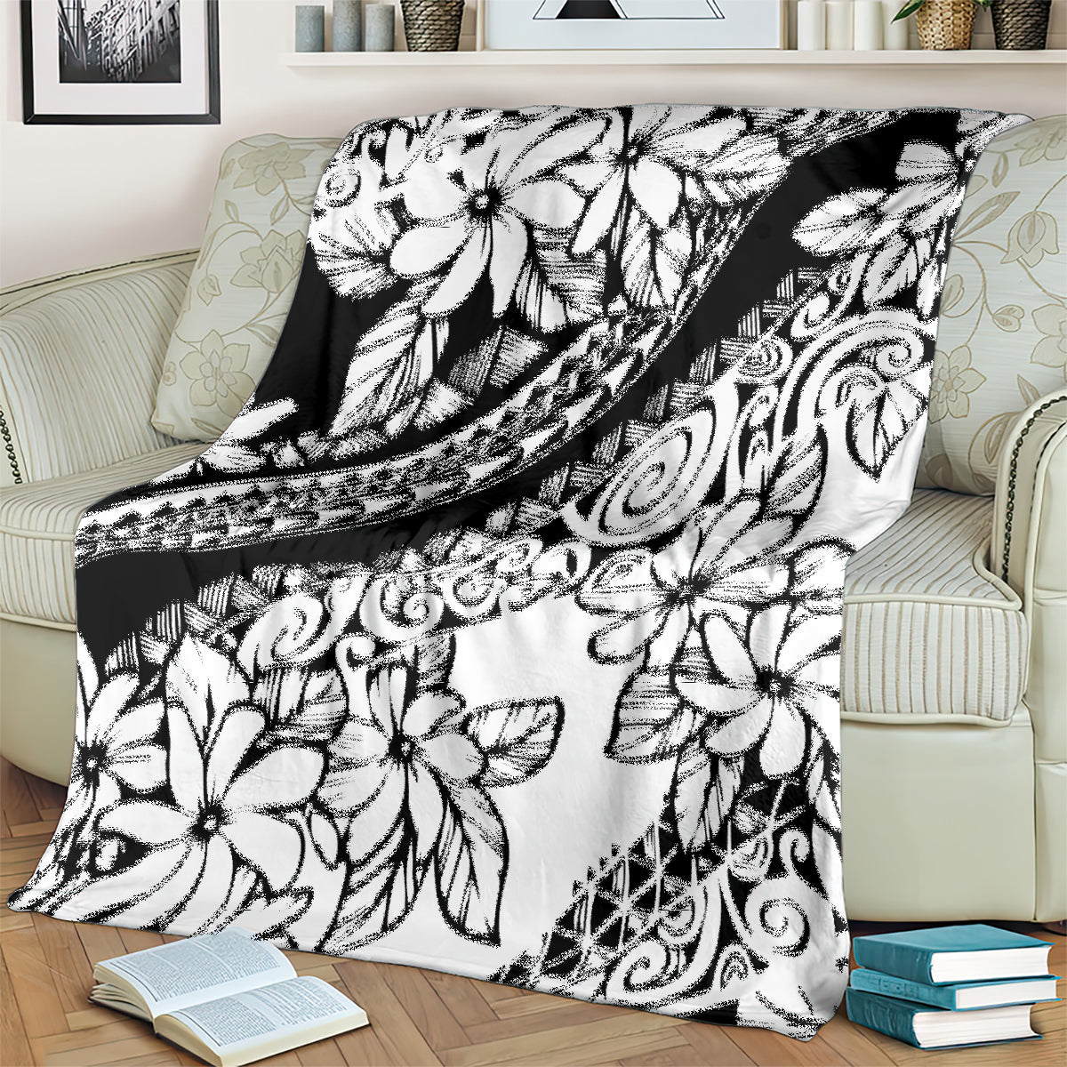 White and black floral blanket with geometric tribal bands, draped on a couch