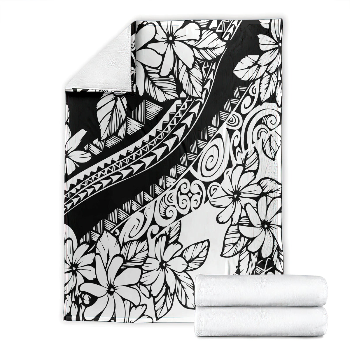 Black and white tropical flower blanket with tribal motifs, laid flat with rolled towels