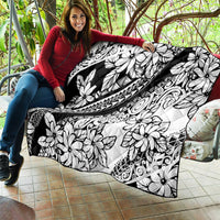 Black-and-white tropical floral quilt with leaf, blossom, and ornamental swirl motifs