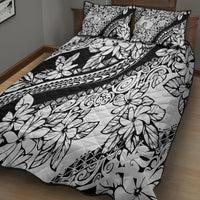 Black and white floral quilt with swirling tribal bands and two pillowcases
