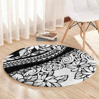 Black round carpet with white floral and tribal designs, clean curved edge
