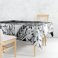 Black-and-white patterned tablecloth draped over dining table