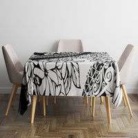 Black-and-white floral tablecloth on dining table with chair corners