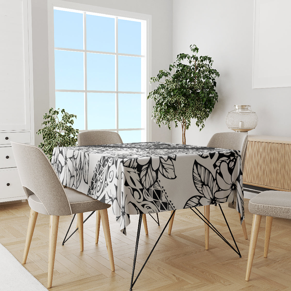 Black-and-white tropical flower tablecloth spread across dining table