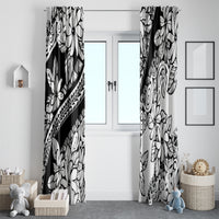 Pair of black and white tropical floral curtains hanging on either side of a doorway