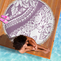 Round purple beach blanket with white tropical graphics and decorative fringe edge