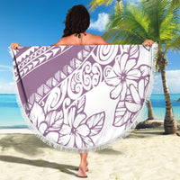 Round beach blanket in purple and white tropical print with fringe border, held up