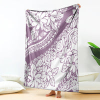 Purple and white Polynesian floral throw blanket, draped over furniture edge
