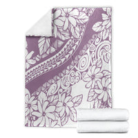 Purple and white Polynesian floral blanket with matching folded towels