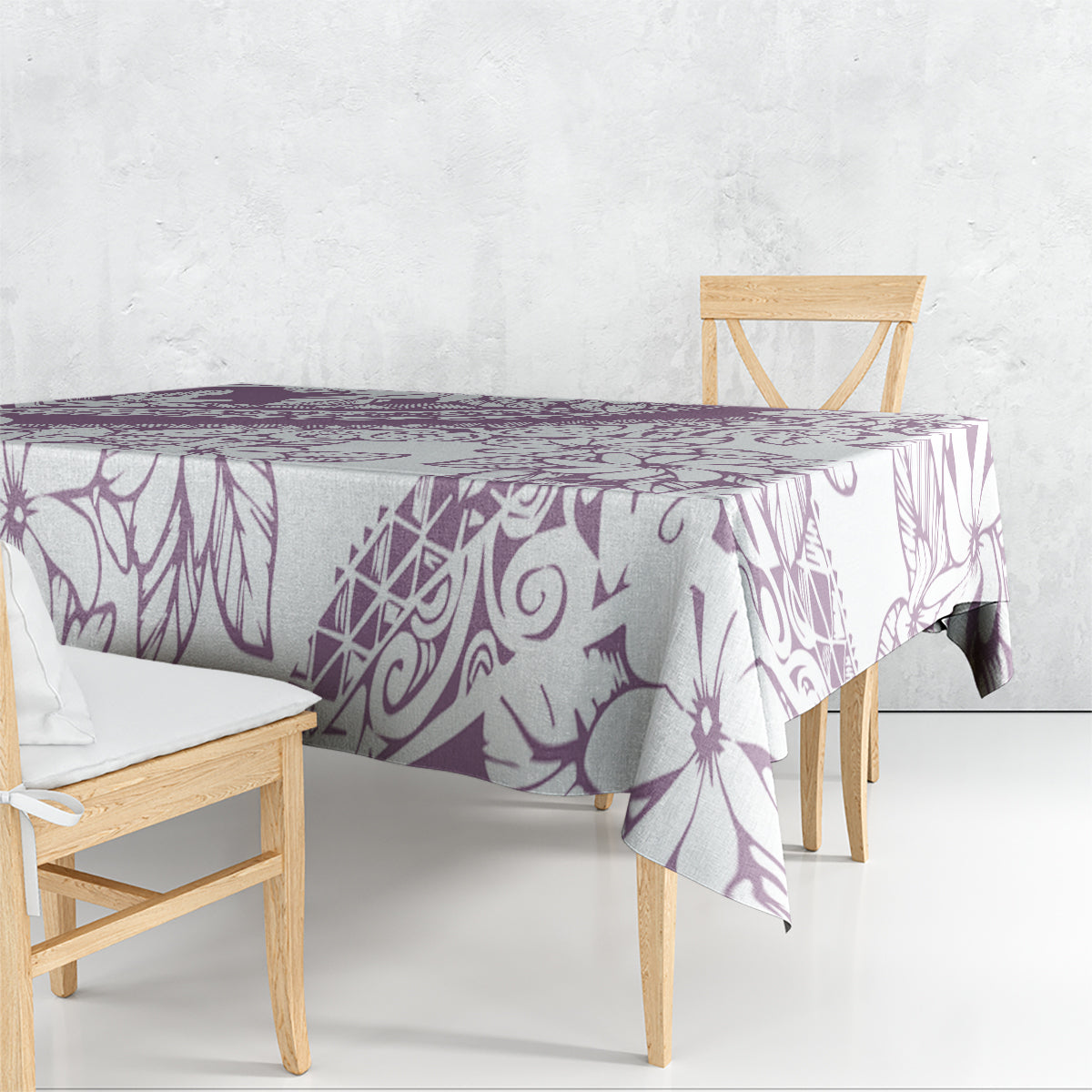Purple and white floral tablecloth draped over dining table with matching pattern.
