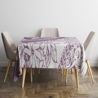 Purple tropical floral tablecloth over rectangular dining table with patterned print.