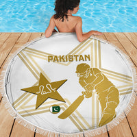 White round beach blanket with gold Pakistan text and cricketer holding bat graphic, fringe