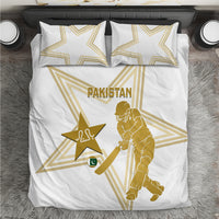 White duvet cover and two pillowcases with gold Pakistan emblem and cricket player graphic