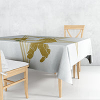 White tablecloth draped on a long table with gold cricket and Pakistan border print