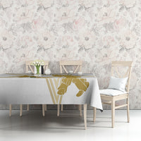 White tablecloth with gold cricket player graphic on a rectangular dining table edge