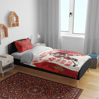 Christmas hockey bedding set on bed with red-and-white Santa design and matching pillow, full duvet view.