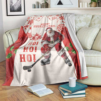 Red and white holiday hockey blanket with Santa player and HO HO HO lettering