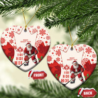 Red hockey-themed ceramic Christmas ornament with Santa and maple leaf pattern, heart shape