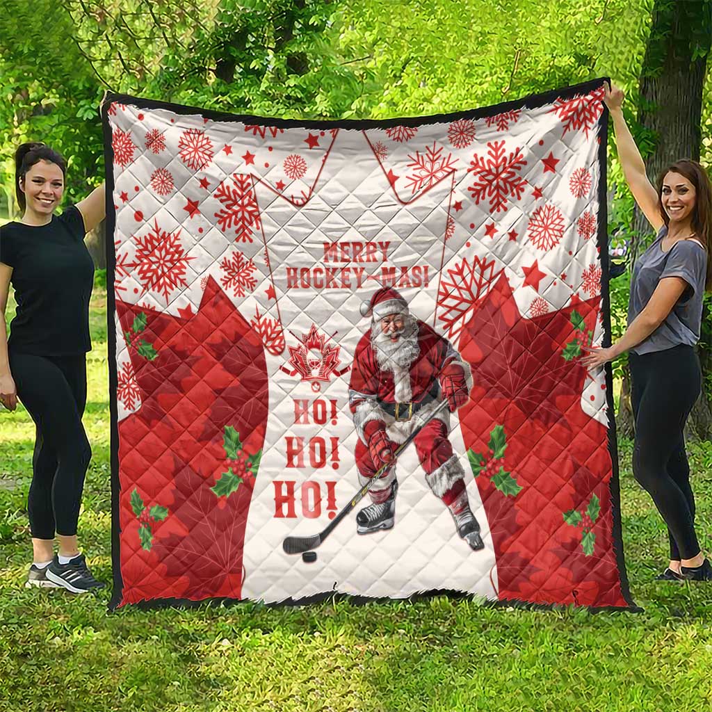 Christmas hockey quilt spread out: red and white quilt with maple leaves, snowflakes, Santa