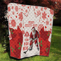 Christmas hockey quilt on grass with red-and-white diamond quilting, maple leaves, Santa