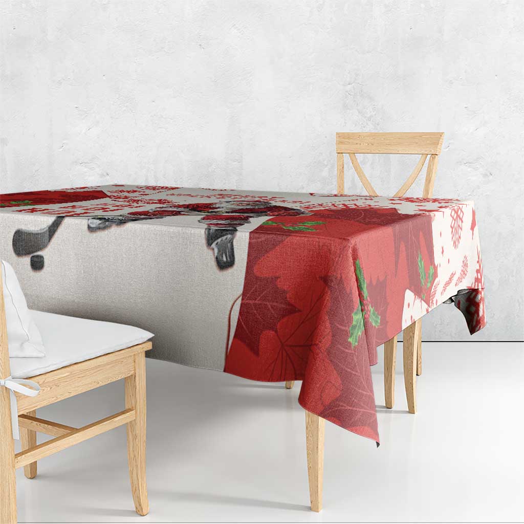 Red and white hockey tablecloth with Santa and maple leaves, draped over table corner