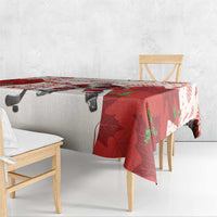 Red and white hockey tablecloth with Santa and maple leaves, draped over table corner