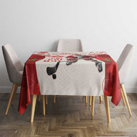 Red and white hockey tablecloth on dining table with hockey Santa and “Ho Ho Ho” text