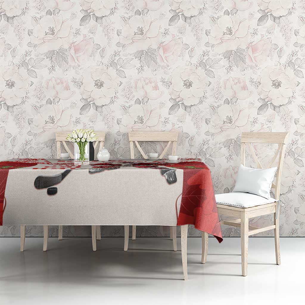 Red and white hockey tablecloth featuring Santa and maple leaves on a dining table