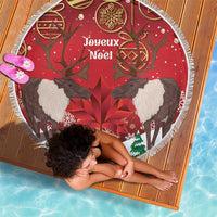 Round red beach blanket with caribou, maple leaf, and Joyeux Noël design
